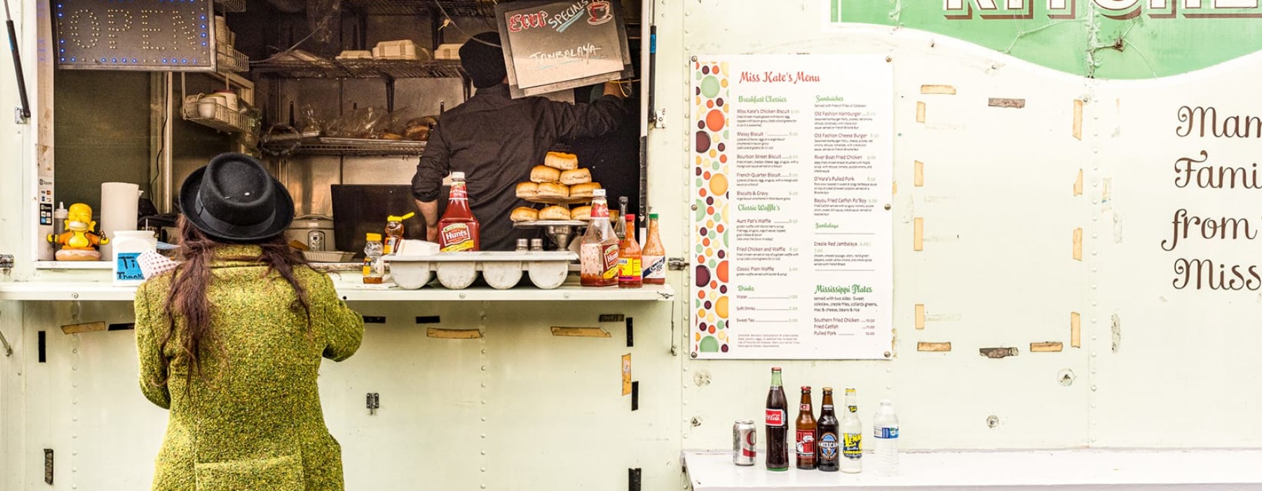 Woman ordering food at a modern food truck 