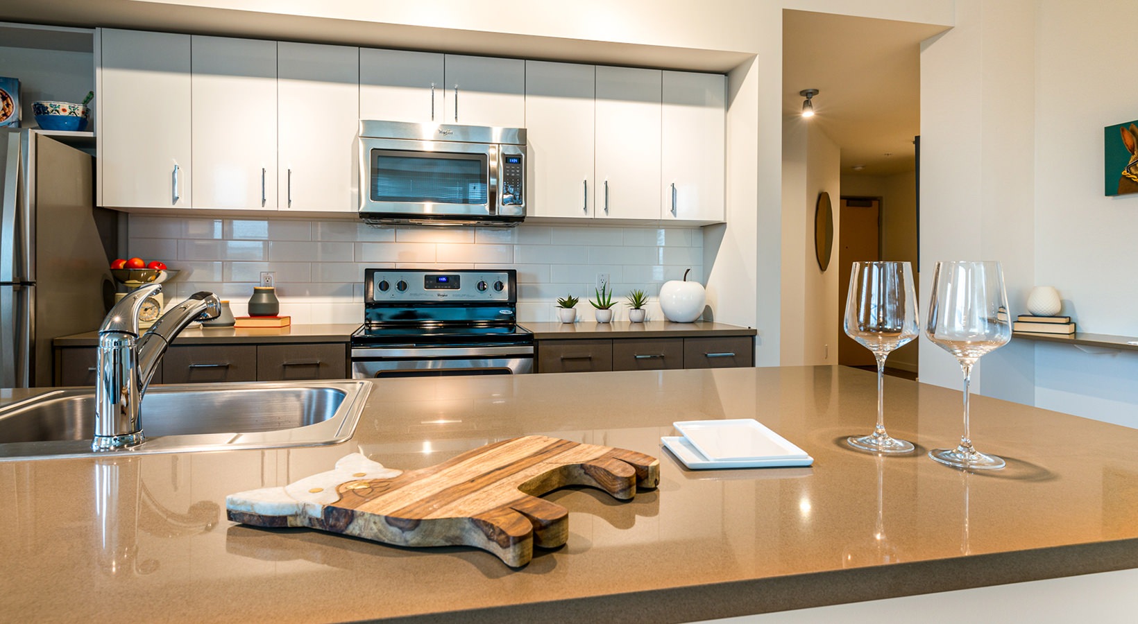 Kitchen Spacious and well lit kitchen with wood floors and stainless steel appliances.